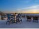 Rooftop deck with tables and chairs, showcasing the beautiful ocean view at 534 Beach Rd, Sarasota, FL 34242