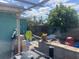 The backyard is designed for fun and relaxation with a hammock and toys at 540 Palmetto Ne Dr, Port Charlotte, FL 33952