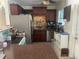 Functional kitchen featuring dark cabinetry, stainless steel appliances, and a breakfast bar at 540 Palmetto Ne Dr, Port Charlotte, FL 33952
