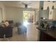 Inviting living room features tile flooring and an open floor plan leading to another room at 540 Palmetto Ne Dr, Port Charlotte, FL 33952