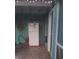 Cozy patio area with refrigerator, brick floor and screened doors at 540 Palmetto Ne Dr, Port Charlotte, FL 33952
