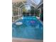 Inviting screened-in pool with clear water and colorful floats, perfect for relaxation and recreation at 540 Palmetto Ne Dr, Port Charlotte, FL 33952
