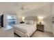 Serene main bedroom featuring a comfortable bed, soft lighting, and a view of the screened lanai at 5710 Palmer Cir # 203, Bradenton, FL 34211