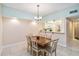 Inviting dining room with a wooden table, seating for six, and a view into the adjacent kitchen at 5734 Ashton Lake Dr # 7, Sarasota, FL 34231