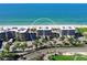 Stunning aerial view of beachfront condos with meticulously landscaped grounds and beautiful views of the Gulf at 575 Sanctuary Dr # A304, Longboat Key, FL 34228