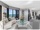 Open-concept living space with neutral decor, ocean views, and sliding door access to the balcony at 575 Sanctuary Dr # A304, Longboat Key, FL 34228