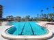 Resort-style swimming pool with lap lanes, shallow end, and lush landscaping at 575 Sanctuary Dr # A304, Longboat Key, FL 34228