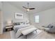 Cozy bedroom with a queen-sized bed, ceiling fan, neutral tones, and ample natural light at 612 Ironwood Cir # 170, Venice, FL 34292