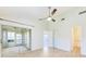 Bright bedroom with tile floors, a ceiling fan, and access to a screened-in patio at 612 Ironwood Cir # 170, Venice, FL 34292