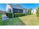 The home has mature landscaping surrounding a screened in porch area at 612 Ironwood Cir # 170, Venice, FL 34292