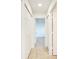 Bright hallway features tile flooring, neutral paint, closet space, and doorway to another room at 612 Ironwood Cir # 170, Venice, FL 34292