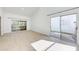Spacious living room featuring large sliding doors, light-colored flooring, and ample natural light at 612 Ironwood Cir # 170, Venice, FL 34292
