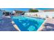 Community pool with lounge chairs, tables and a covered seating area at 612 Ironwood Cir # 170, Venice, FL 34292