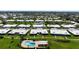 An aerial of this lovely neighborhood, featuring lush green lawns, mature trees, and a sparkling community pool at 6902 8Th W Ave, Bradenton, FL 34209