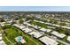 An aerial view displays the community, highlighting the neatly arranged residences, verdant lawns, and inviting swimming pools at 6902 8Th W Ave, Bradenton, FL 34209