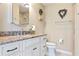 Well-lit bathroom with granite countertop, white cabinets, and decorative accents at 6902 8Th W Ave, Bradenton, FL 34209