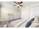 Bright bedroom featuring wood-look floors, ceiling fan and double closets for ample storage at 6902 8Th W Ave, Bradenton, FL 34209
