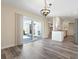 Dining room with sliding glass doors, kitchen view, and chandelier lighting at 6902 8Th W Ave, Bradenton, FL 34209
