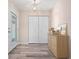 Entryway with wood-look floors, closet, and stylish light fixture at 6902 8Th W Ave, Bradenton, FL 34209