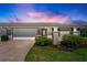Charming single-story home featuring a two-car garage and a beautifully landscaped front yard at 6902 8Th W Ave, Bradenton, FL 34209