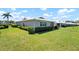 Single Gathering home surrounded by a plush green lawn and well maintained landscaping at 6902 8Th W Ave, Bradenton, FL 34209