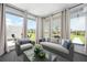 Cozy living room featuring large windows, comfortable seating, and a view of the well-manicured lawn at 6902 8Th W Ave, Bradenton, FL 34209