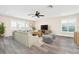 Living room featuring wood floors, comfortable sofa, and large windows at 6902 8Th W Ave, Bradenton, FL 34209
