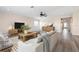 Well staged living room featuring new wood-look floors, ceiling fan, and neutral colors at 6902 8Th W Ave, Bradenton, FL 34209