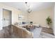 Comfortable living room with a sofa, area rug, and a view of the adjacent washroom at 6902 8Th W Ave, Bradenton, FL 34209