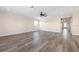 Living room featuring new wood-look floors, ceiling fan, and neutral colors at 6902 8Th W Ave, Bradenton, FL 34209