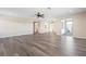 Living room featuring new wood-look floors, ceiling fan, and neutral colors at 6902 8Th W Ave, Bradenton, FL 34209