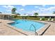 Community pool with brick patio, chairs for lounging, and lots of sunshine at 6902 8Th W Ave, Bradenton, FL 34209