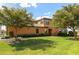 Beautiful home featuring manicured landscaping, a tile roof and a well-maintained lawn at 6918 Grand Estuary Trl # 104, Bradenton, FL 34212