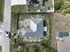 The aerial view highlights a newly constructed metal roof home on a large treed lot at 6970 Beckwith Ave, North Port, FL 34291