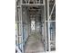 Interior framing of a building showing metal studs, wiring, and pipes running throughout at 6970 Beckwith Ave, North Port, FL 34291