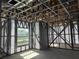 Interior view of a framed home showing metal beams and studs for walls, plus a view from a window at 6970 Beckwith Ave, North Port, FL 34291