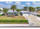 A high-angle view showcasing the home, its landscaping, the driveway, and surrounding neighborhood at 7337 Starfish Dr, Sarasota, FL 34231