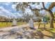 A gated community entrance featuring mature trees, statues, and signage, offers privacy and exclusivity to residents at 7337 Starfish Dr, Sarasota, FL 34231