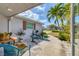 Cozy front porch area with seating, decorative water fountain, and vibrant landscaping at 7337 Starfish Dr, Sarasota, FL 34231