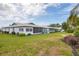 Attractive home with a well-manicured lawn, mature landscaping, and a view of neighboring houses at 7402 8Th W Ave, Bradenton, FL 34209