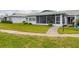 Well-maintained home with lush green lawn and sidewalk leading to the entrance at 7402 8Th W Ave, Bradenton, FL 34209