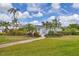 Charming home with well-maintained landscaping, palm trees, and inviting curb appeal at 7402 8Th W Ave, Bradenton, FL 34209