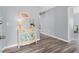 View of the entrance hall with decorative table, beach themed artwork and hardwood floors at 7402 8Th W Ave, Bradenton, FL 34209
