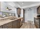 Modern kitchen featuring granite countertops, stainless steel appliances, and wood-look floors at 7402 8Th W Ave, Bradenton, FL 34209