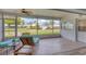 Relaxing screened lanai showcasing wood-look tile flooring and beautiful outdoor view at 7402 8Th W Ave, Bradenton, FL 34209