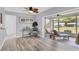 Bright living room featuring access to screened lanai and comfortable lounge chairs at 7402 8Th W Ave, Bradenton, FL 34209