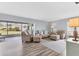 Inviting living room with stylish furnishings, wood look flooring and a view of the outdoor space at 7402 8Th W Ave, Bradenton, FL 34209
