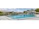 Inviting community pool area surrounded by lush landscaping, with comfortable lounge seating at 7402 8Th W Ave, Bradenton, FL 34209