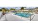 Community pool showcasing a covered seating area, lounge chairs, and clear blue water at 7402 8Th W Ave, Bradenton, FL 34209