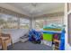 Enclosed sunroom area with multiple windows and a ceiling fan at 7402 8Th W Ave, Bradenton, FL 34209